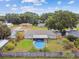 An aerial view of the home with a fenced in backyard featuring an above ground pool at 12106 Meadow Ln, San Antonio, FL 33576