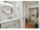 Bathroom featuring gray vanity and decor, conveniently located next to the bedroom at 12106 Meadow Ln, San Antonio, FL 33576