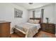 Cozy bedroom with wood floors, neutral walls, and a full size bed at 12106 Meadow Ln, San Antonio, FL 33576