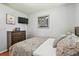 Comfortable bedroom with a dresser, wall-mounted TV, and tasteful artwork at 12106 Meadow Ln, San Antonio, FL 33576