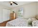 Comfortable bedroom featuring a bed, dresser, closet, and natural lighting at 12106 Meadow Ln, San Antonio, FL 33576