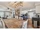 Dining room with wood floors and a fireplace feature and an open concept to the kitchen at 12106 Meadow Ln, San Antonio, FL 33576