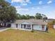 Charming single-story home with a well-maintained lawn and inviting front porch seating at 12106 Meadow Ln, San Antonio, FL 33576