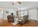 Comfortable living room with a plush sofa, modern entertainment center, and stylish ceiling fan at 12106 Meadow Ln, San Antonio, FL 33576