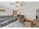 Open-concept living room showcasing a fireplace and comfortable gray sofa at 12106 Meadow Ln, San Antonio, FL 33576