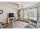 Inviting living room with a comfortable sofa, large windows, and stylish decor at 12106 Meadow Ln, San Antonio, FL 33576