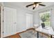 Office area showcasing closet space, window with blind, desk, and hardwood flooring at 12106 Meadow Ln, San Antonio, FL 33576