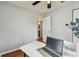 Office area with modern desk setup, laptop, and view to an adjacent bathroom at 12106 Meadow Ln, San Antonio, FL 33576