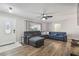 Cozy living space with hardwood floors, a gray sectional sofa, and an open doorway at 12343 Ascot Ln, Spring Hill, FL 34609