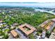 Aerial view of community buildings with mature trees, lush greenery, parking and nearby waterways at 12760 Indian Rocks Rd # 578, Largo, FL 33774