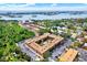 Aerial view of community buildings with mature trees, lush greenery, parking and nearby waterways at 12760 Indian Rocks Rd # 578, Largo, FL 33774