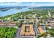 Aerial view of community buildings with mature trees, lush greenery, parking and nearby waterways at 12760 Indian Rocks Rd # 578, Largo, FL 33774