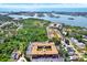 Aerial view of community buildings with mature trees, lush greenery, parking and nearby waterways at 12760 Indian Rocks Rd # 578, Largo, FL 33774