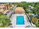 Aerial view of community pool, pool house, parking and lush green landscaping at 12760 Indian Rocks Rd # 578, Largo, FL 33774