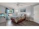 Comfortable bedroom with wood-look floors, ceiling fan, and lots of natural light from the window at 12760 Indian Rocks Rd # 578, Largo, FL 33774