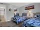 Bedroom featuring two twin beds, mirrored closet doors, and a coastal-themed decor at 12760 Indian Rocks Rd # 578, Largo, FL 33774