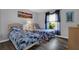 Bright bedroom featuring two twin beds, wood floors, and ample natural light at 12760 Indian Rocks Rd # 578, Largo, FL 33774