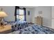 Comfortable bedroom with twin beds, wood floors, natural light, and tasteful decor at 12760 Indian Rocks Rd # 578, Largo, FL 33774
