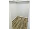 Walk-in closet providing ample storage space with wood-look flooring and bright lighting at 12760 Indian Rocks Rd # 578, Largo, FL 33774