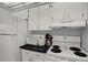 Functional kitchen with white appliances, black countertops, and ample cabinet space at 12760 Indian Rocks Rd # 578, Largo, FL 33774