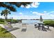 Outdoor patio area with waterfront views, lounge chairs and picnic tables, perfect for relaxing and entertaining at 12760 Indian Rocks Rd # 578, Largo, FL 33774