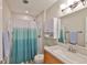 Clean bathroom featuring a shower with a curtain, and a vanity at 1304 Burbank Ct, Sun City Center, FL 33573