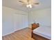 A clean bedroom featuring laminate flooring and closet space at 1304 Burbank Ct, Sun City Center, FL 33573