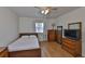 A cozy bedroom featuring laminate flooring and a ceiling fan at 1304 Burbank Ct, Sun City Center, FL 33573