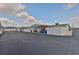 Carport view of home with two parking spaces, seating, and landscaping at 1304 Burbank Ct, Sun City Center, FL 33573