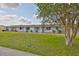 Well-maintained front lawn with view of home with lush green grass and landscaping at 1304 Burbank Ct, Sun City Center, FL 33573