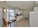 Bright kitchen featuring modern appliances, tile flooring and a breakfast nook with sliding glass doors at 1304 Burbank Ct, Sun City Center, FL 33573