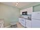 Bright kitchen featuring stone countertops and white cabinets at 1304 Burbank Ct, Sun City Center, FL 33573