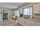 Bright eat-in kitchen featuring granite countertops and stainless steel sink at 1304 Burbank Ct, Sun City Center, FL 33573