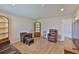 Spacious living room featuring beautiful floors, neutral walls and traditional wood shelving at 1304 Burbank Ct, Sun City Center, FL 33573