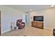 Cozy living room with beautiful floors, accent furniture and a large TV for entertainment at 1304 Burbank Ct, Sun City Center, FL 33573