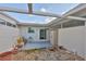 Enclosed patio has a sliding glass door, a storage closet, and stone landscaping at 1304 Burbank Ct, Sun City Center, FL 33573