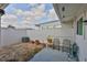 Enclosed patio features stone landscaping, two chairs, and plenty of sunlight at 1304 Burbank Ct, Sun City Center, FL 33573