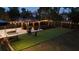 Backyard with a gazebo, patio furniture, string lights and artificial turf at 1357 S Betty Ln, Clearwater, FL 33756