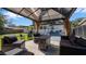 Inviting backyard patio with stylish seating, a fire pit, and a charming gazebo, perfect for outdoor relaxation at 1357 S Betty Ln, Clearwater, FL 33756