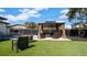 Backyard with outdoor seating under a gazebo and artificial grass at 1357 S Betty Ln, Clearwater, FL 33756