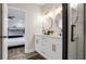 Bright bathroom features dual sinks, striking gold accents, and a glass enclosed shower at 1357 S Betty Ln, Clearwater, FL 33756