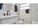 Clean and modern bathroom features white cabinets and striking black accents at 1357 S Betty Ln, Clearwater, FL 33756