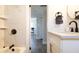 Bright bathroom featuring marble tile, updated vanity, and modern fixtures at 1357 S Betty Ln, Clearwater, FL 33756