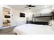 Bright bedroom features a bunk bed, a queen bed, and a modern dresser with a wall-mounted television at 1357 S Betty Ln, Clearwater, FL 33756