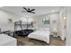 Well-lit bedroom featuring a full bed, bunk bed, ceiling fan, and modern decor at 1357 S Betty Ln, Clearwater, FL 33756