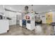 Open-concept kitchen featuring white cabinets, a center island cooktop, and wood flooring at 1357 S Betty Ln, Clearwater, FL 33756