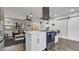 Bright kitchen with a center island cooktop, shaker style cabinets, and stainless-steel appliances at 1357 S Betty Ln, Clearwater, FL 33756