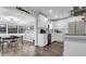Bright kitchen with white cabinets, stainless steel appliances, and an eat-in area with natural light at 1357 S Betty Ln, Clearwater, FL 33756