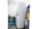 Compact laundry area with stacked washer and dryer, plus water heater at 1357 S Betty Ln, Clearwater, FL 33756