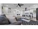 Open-concept living area featuring modern furnishings, a ceiling fan, and an adjacent kitchen area at 1357 S Betty Ln, Clearwater, FL 33756